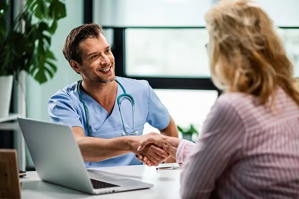Doctor and woman shaking hands