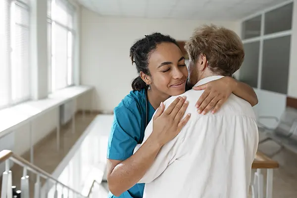 Woman and doctor hugging
